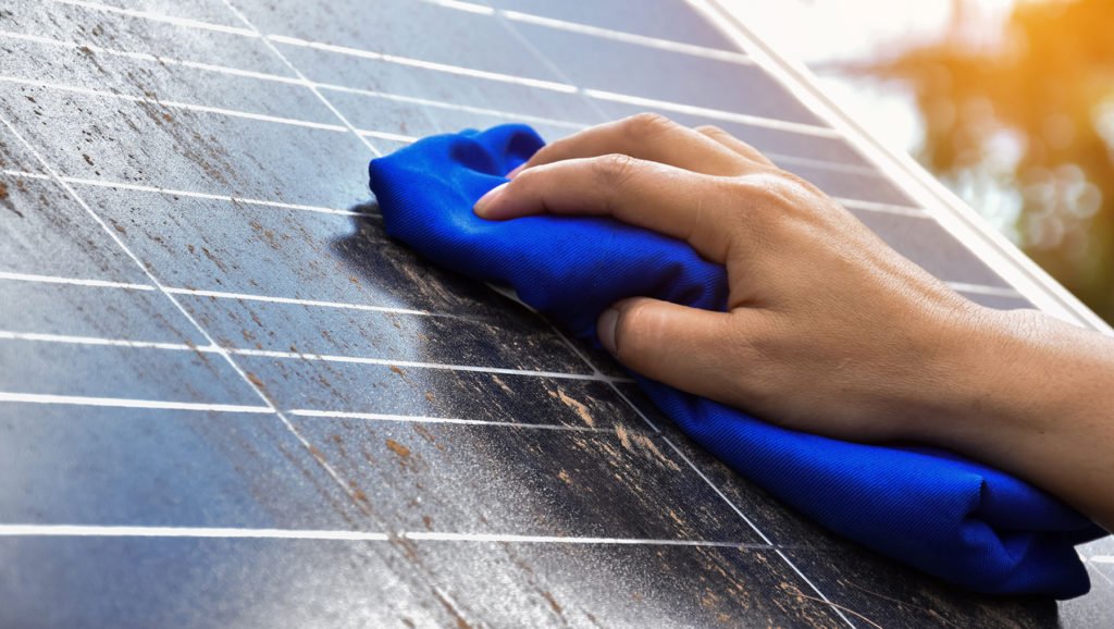 Person-Who-Is-Cleaning-Solar-Panels
